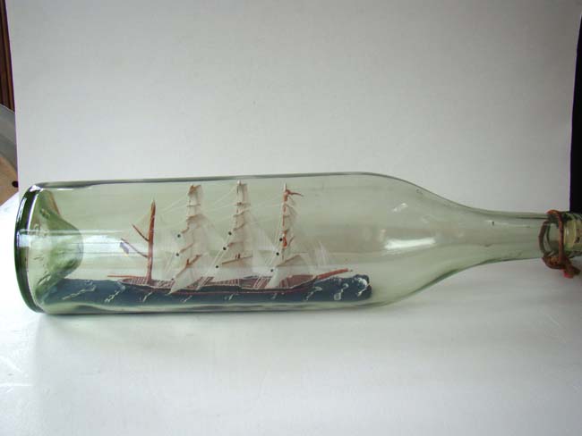 A nicely made four masted ship-in-a 19" long bottle circa 1950
